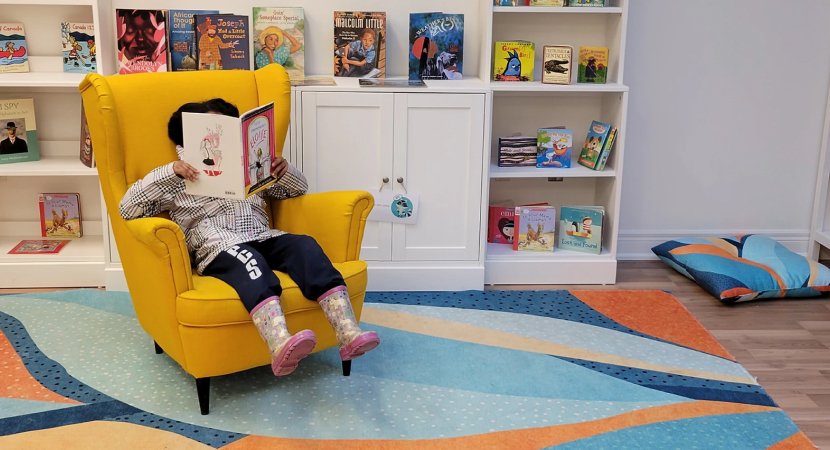 child reading in a chair